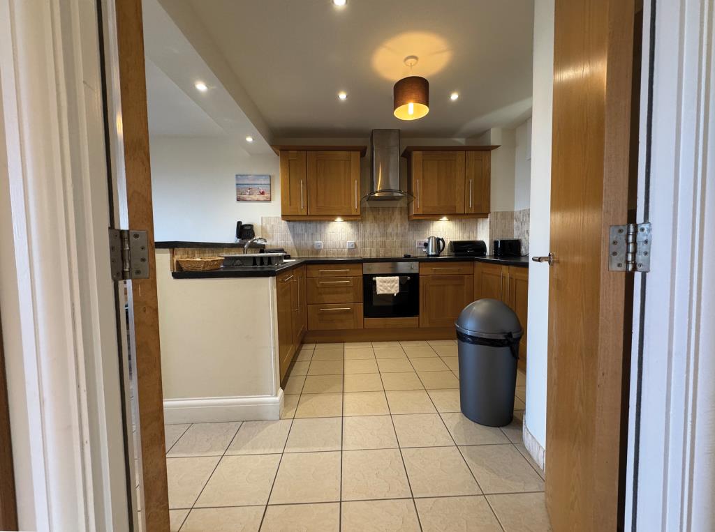 Lot: 78 - TOP FLOOR HOLIDAY APARTMENT WITH SEA VIEWS - Kitchen area from the hallway